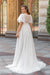 Robe de mariée empire grande taille vue de dos, dos transparent en dentelle, manches papillon en tulle et traîne fluide